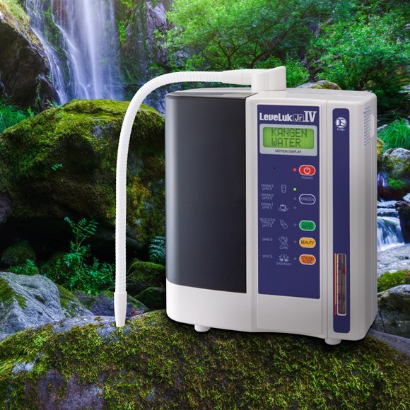 Leveluk Jr IV on a mossy rock beside a waterfall